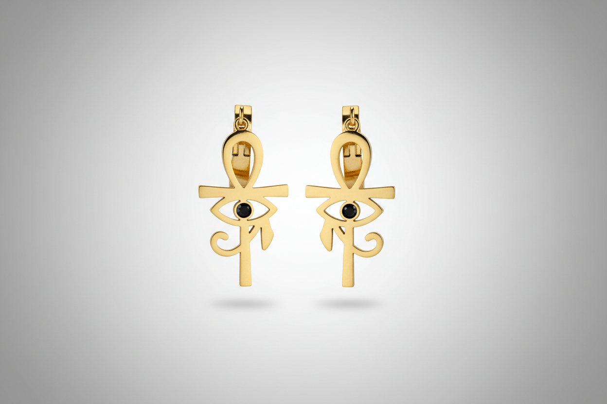 pendientes de acero dorado curz egipcia, con cristal negro en el centro.