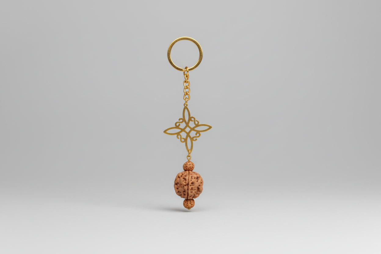 Llavero acero dorado, nudo de bruja y Rudraksha. IVA incluido.