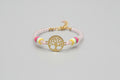Pulsera de cuentas  cristal rosa  claro con cierre cuerda y dije árbol. IVA incluido