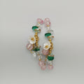 Pulsera de cuentas color rosa claro con flores fantasía. IVA incluido