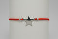 Pulsera elástica rojo amuleto estrella acero. IVA incluido