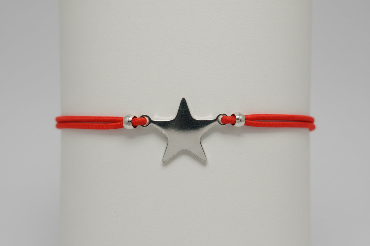 Pulsera elástica rojo amuleto estrella acero. IVA incluido