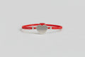 Pulsera elástica roja con amuleto corazón a cero. IVA incluido